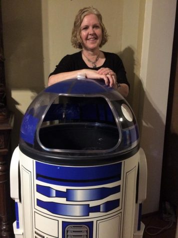 Christine Nobbe, Instructional Coach, poses with a piece from her R2D2 collection.