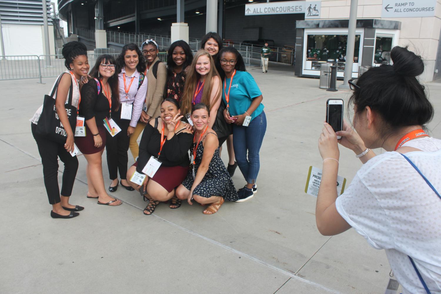 Hang Ying, a high school journalist from Madison, Wisconsin, take a picture of a group of Summer Journalism Program students. Moments later, students began to cover the Jets VS. Titans football game from the press box at Metlife Stadium in New York. 