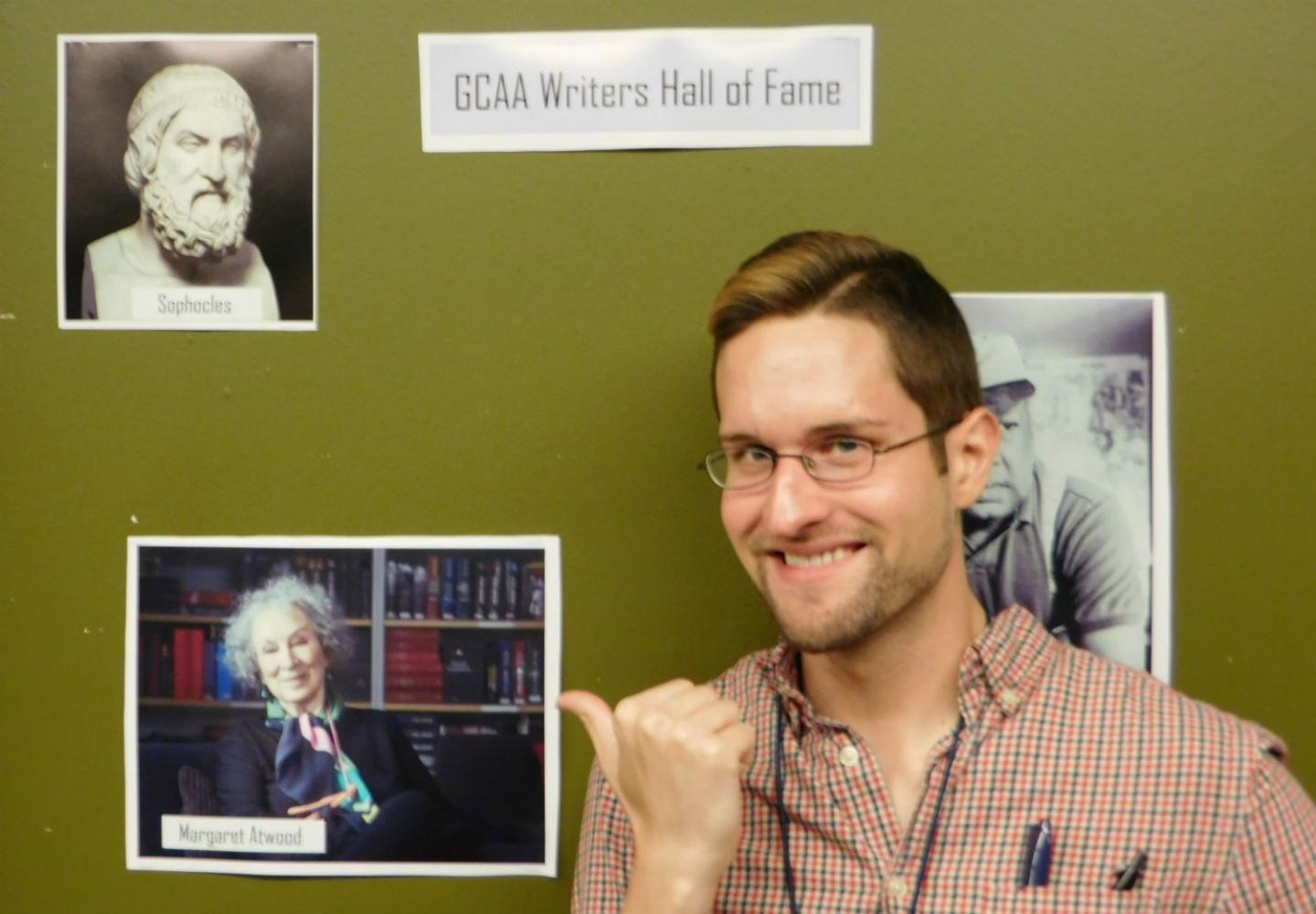 VonNoordheim poses next to the picture of his favorite author, Margaret Atwood, in the hallway on the 4th floor.