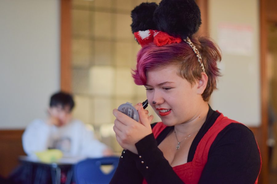 Sophomore Mia King applies makeup to complete her Minnie Mouse costume.  
I love any excuse to dress up...I was trying to think of the most famous female cartoon character and its Minnie Mouse., King said.