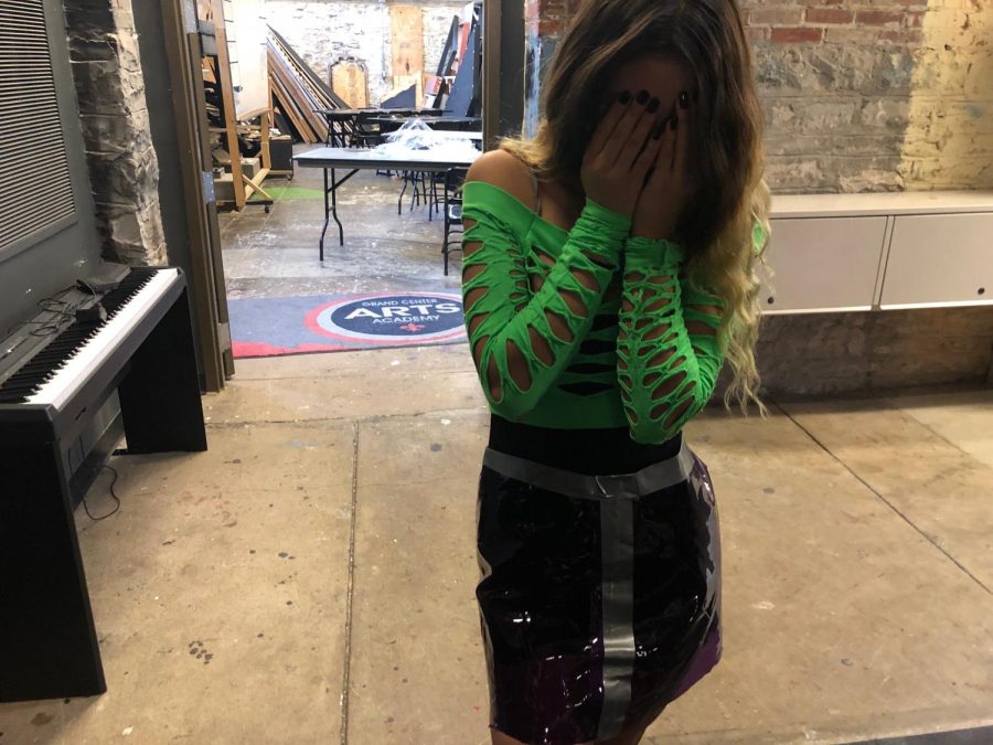 Wearing a recycled skirt, ---- grader Savannah Garcia hangs out backstage prior to the start of the show. Can I cover my face? she asked.