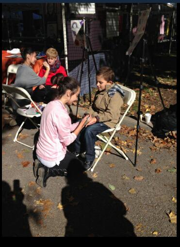 Sophie Iffrig, and Keeley Barket raising funds for the school at the ‘Shaw Art fair,’ by charging money for face painting.
