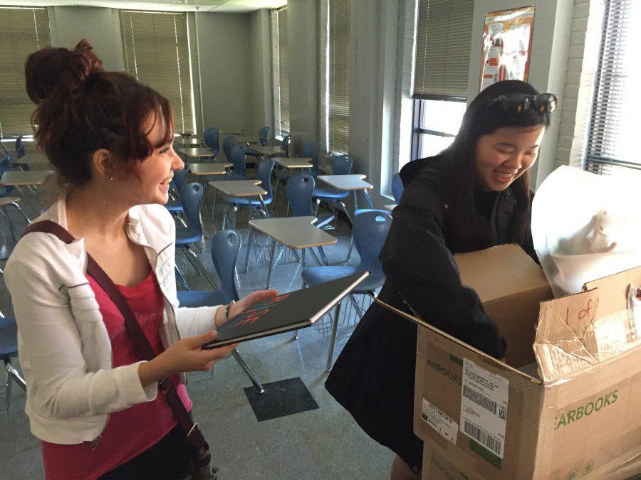 In a May 13, 2016 photo, Keeley Burke, 2017 Expression Editor-in-Chief (right) and Emma Iffrig, former Expression Editor-in-Chief (left), smile as they open the first box of newly delivered yearbooks. The 2016 Expression yearbook earned a first class rating from the National Scholastic Press Association. 