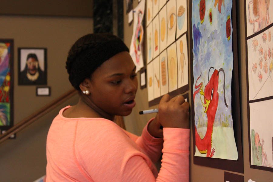 Kalleigh Matthews, 8th grade, signs collage project of butterscotch candy.  The project was about taking an everyday object and imagining 14 different ways it could look.