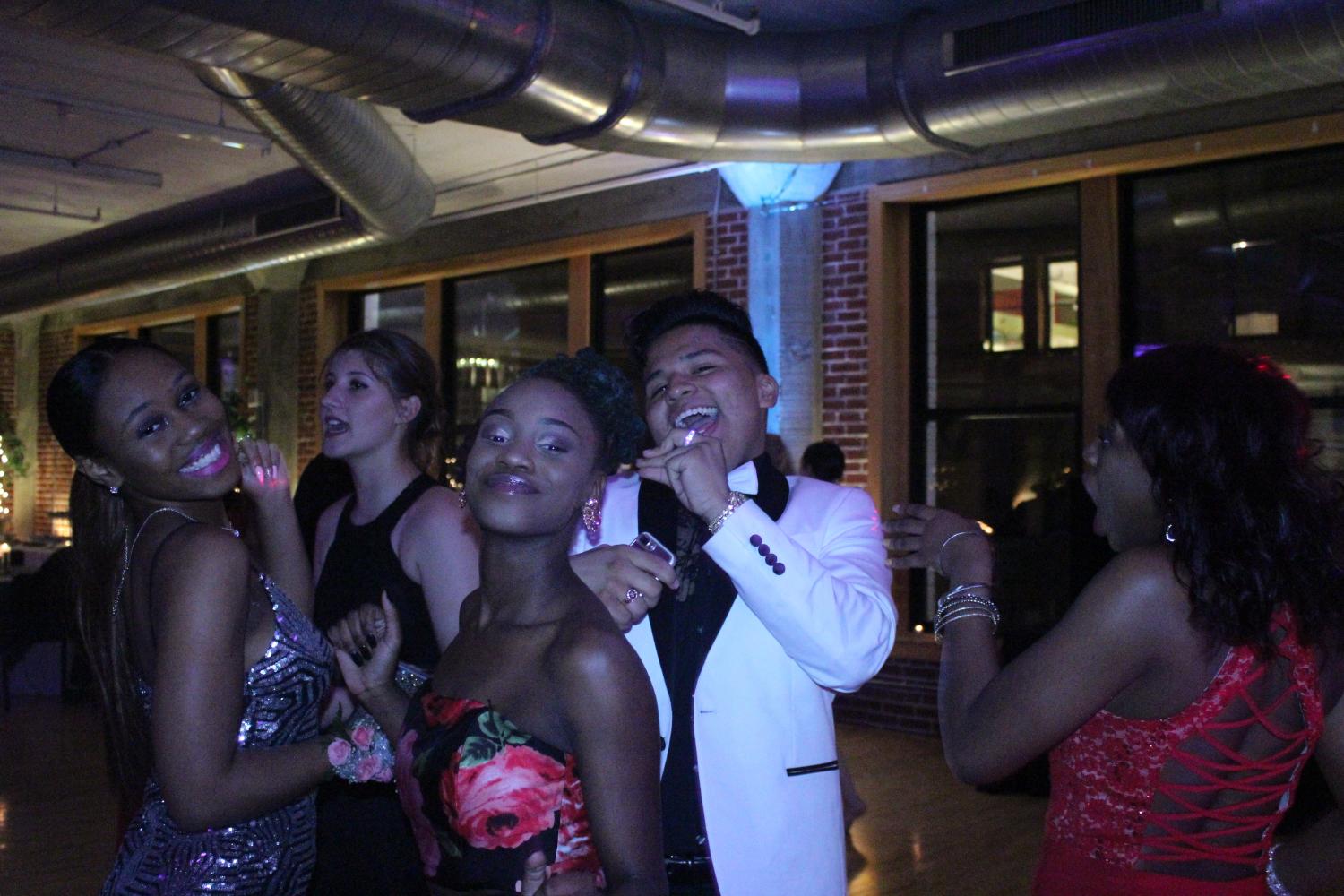 (Left to right) Juniors Crystal Woods, Mariah Watson, and Anthony Orozco pose for a picture. "My favorite part of prom was being surrounded by all of my friends and just having a good time, and seeing everyone in their beautiful outfits," said Orozco.