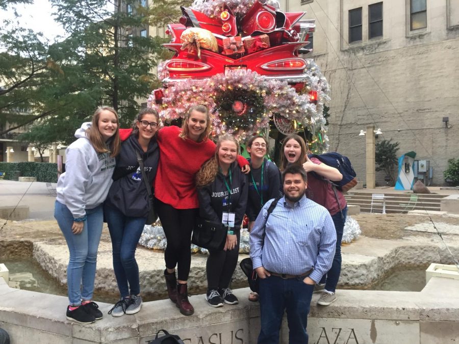 Caroline Knapp, Tessa Wild, Quinlan Holt, Elyse Luecke, Brooke Schuessler, Natalie O'Dell and adviser Travis Armknecht pose for a picture in downtown Dallas near Pegasus Plaza. "I think this award reflects all of the hard work I've been doing ever since I first joined staff," said Knapp. 