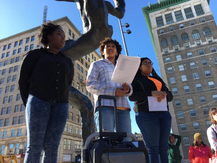 Imani Smith, 8th grade, Patra Patton, senior, and Jorja McAfee, junior, pause for a moment of silence in honor of the 17 students killed in the Marjory Stoneman Douglass school shooting. Patton then listed how many students have been killed in each attack since Columbine. 