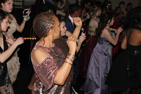 Gina Bell-Moore dance with students during prom.