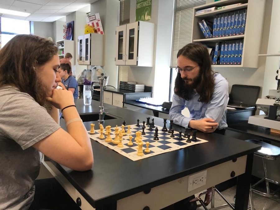 Lillian Selligman (left) and Chris Corriveau (right) play chess together in advisory.