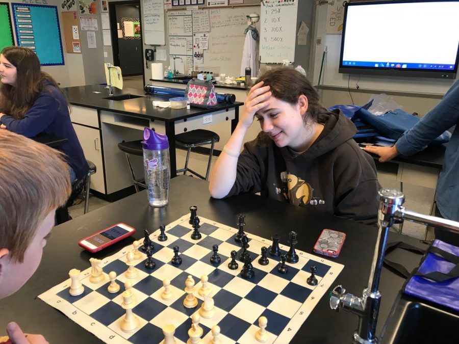 Lillian Selligman (right) contemplates her next move as she plays against Joseph Miller (left).