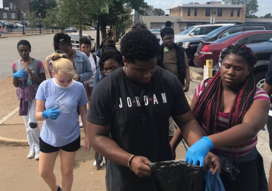 Theater teacher Brandon Riley walks with sophomore Gloria Manning, followed by other theater students. 
"It wasn’t like we were just doing it cause we were in ISS, we were doing it because we wanted to. He even said we could sit down if we didn’t want to do it...I grabbed the glove," Manning said.