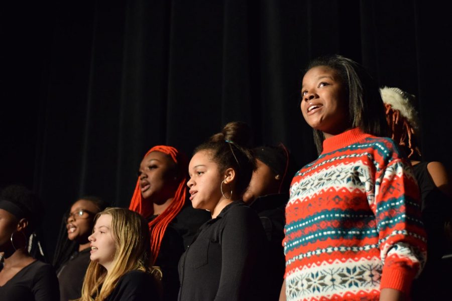 Sophomore Dee Brown performs with Concert Choir Treble in a Christmas sweater.  “I was told that it would be okay to wear Christmas-y things, and when I showed up everybody’s wearing all black, and I thought ‘well I brought an ugly Christmas sweater, and so I went up to Mr. Rhodes and I said ‘hey, can I wear this? I didn’t know if it was okay’ and he said ‘just go for it’,” said Brown.