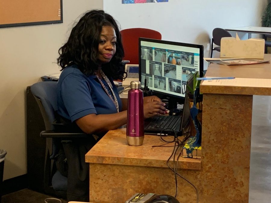 Officer Zina Bush monitors security feeds in the school foyer.