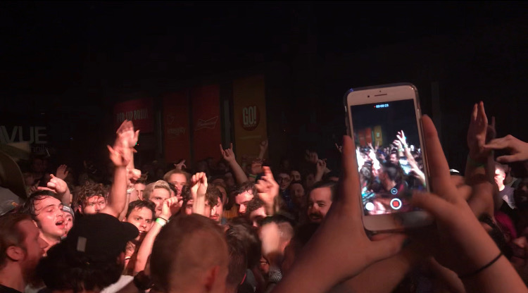 Canadian Punk singer from the band PUP, Stefan Babcock, preforming in the crowd at Delmar Hall. Fans sing along and dance in excitement.