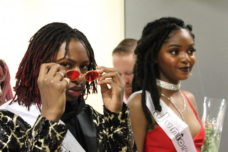 Ready to walk down the aisle for Homecoming court junior prince Haile Emerson gives the camera a glance while junior princess Jakyah Overton smiles for the crowd. “I ran for homecoming prince because freshman year I humiliated myself so I wanted to redeem myself, simply, Emerson said. 