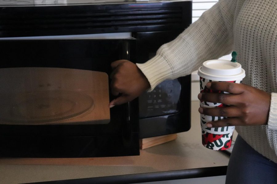 Microwaves are back and are in use! Senior Mya Wraggs heats up her coffee in the North cafeteria.